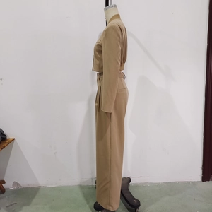 Side view of khaki casual suit set with cropped jacket and straight-leg trousers on mannequin
