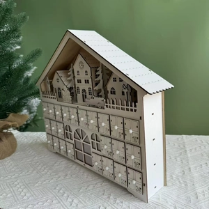 Macro view of white wooden Christmas advent calendar with 24 drawers and winter scene
