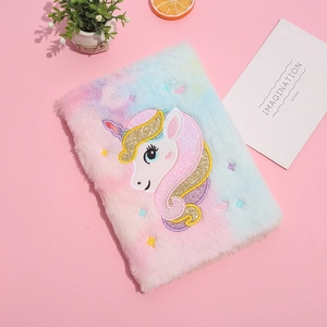 Rainbow plush unicorn notebook with sequin embroidery on a soft pink background