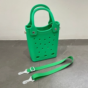 Detail of green EVA beach bag showing hole-perforated texture and detachable strap