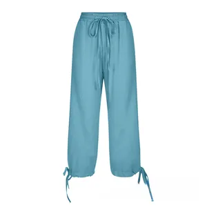 Detail view of cotton linen wide-leg pants featuring elastic drawstring waist and hem cords