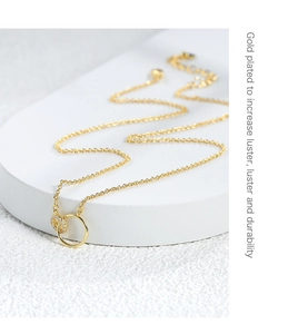 Detail of interlocking gold-plated double rings featuring pave-set cubic zirconia accents