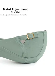 Detail shot of the adjustable bronze metal buckle on the green cotton ivy newsboy cap