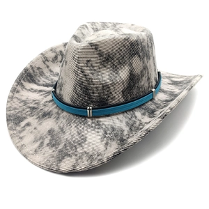 Detail of western cowboy hat featuring tie-dye pattern and textured corduroy fabric