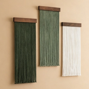 Three-piece bohemian cotton fringe wall hanging with dark walnut wood rod on beige wall