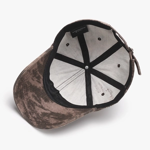 Internal view of a washed distressed camo baseball cap with a metal adjustable strap