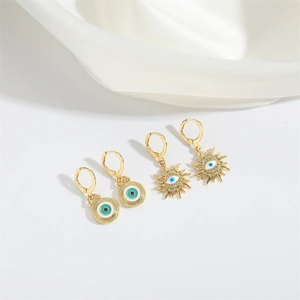 Detail view of retro gold Devil's Eye earring set with enamel and small crystals