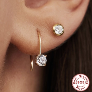 925 sterling silver gold plated hoop earrings with round clear crystals on female model