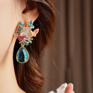 Detailed close-up of vintage butterfly drop earrings featuring zircon and colorful enamel