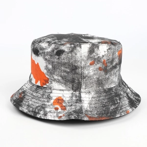 Detailed close-up of tie-dye bucket hat fabric showing canvas texture and color pattern