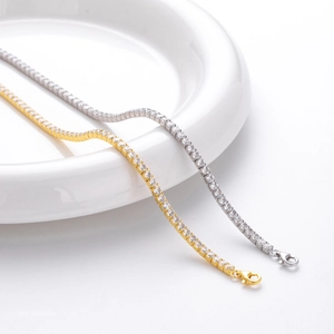 Detail of silver and gold tennis bracelets with lobster clasp and cubic zirconia