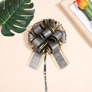 Detail of black gold mesh bow ribbon with bark texture and elegant golden edges
