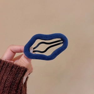 Irregular dark blue flocked wave hair clip with a warm velvet texture and metal base