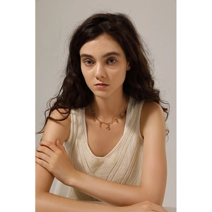Detailed view of 18K gold-plated stainless steel necklace with DIY charms on a model