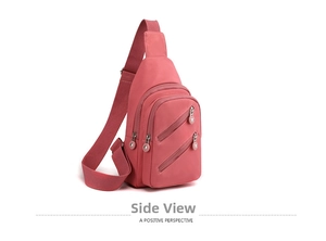 Side view of pink nylon crossbody bag showing multiple zip pockets and layered structure