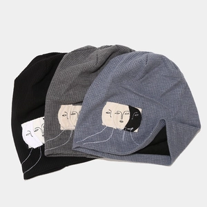 Three-color waffle knit beanies with abstract face patch in black, grey, and blue colors