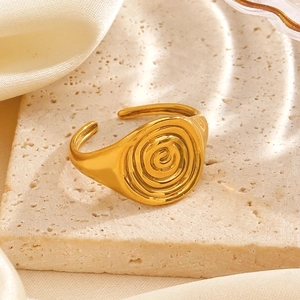 Minimalist 18K gold plated spiral ring with adjustable open band on stone surface