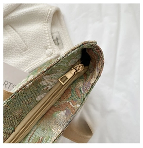 Detail of high-quality smooth metal zipper and floral jacquard fabric on a tote bag