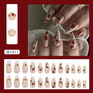 Almond fake nails with floral tulip patterns and elegant gold trim detailing