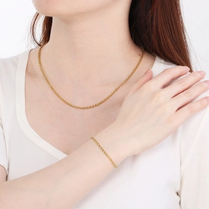 Elegant gold plated stainless steel link chain necklace and bracelet set on model