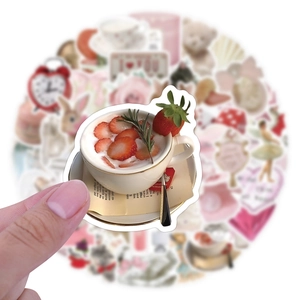 Close-up of strawberry tea sticker with cute coquette style patterns for laptop decor