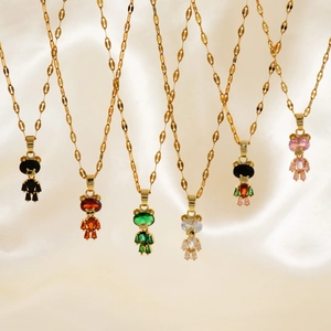 Detailed display of six colorful bear pendants on gold chains over cream silk fabric