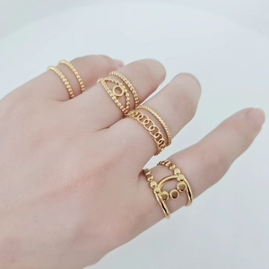 Detail of 18K gold-plated stainless steel rings showing intricate chain and beaded textures