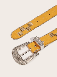Detail of yellow crocodile pattern belt with rhinestone buckle and punk style studs
