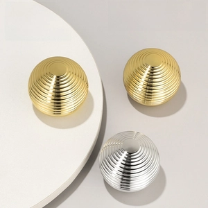 Detail view of 30g acrylic cosmetic jars with luxury spiral texture in gold and silver