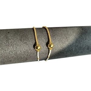 Minimalist gold metal pipe earrings with bead and pearl on a grey display stand