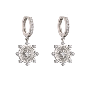 Detail of silver starburst drop earrings with micro-p鑲zirconia on white background