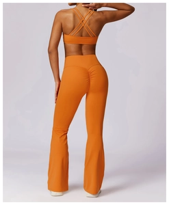 Detail of orange cross-back sports bra and flare yoga pants with scrunch butt lifting design