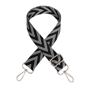 Close-up of black and white herringbone canvas bag strap with silver metal hardware
