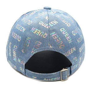 Detail of adjustable silver buckle on blue denim baseball cap with holographic text