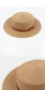 Detailed macro view of brown straw flat top hat with buckled leather strap detail