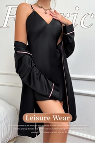 Detail of black silk satin robe and camisole dress with pink contrast piping edge