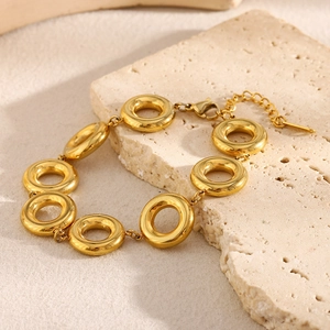 Detailed shot of 18K gold plated stainless steel chunky ring link bracelet on stone