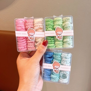 Three packs of pastel ruffled elastic hair bands for kids in clear gift boxes