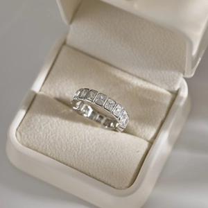 Macro shot of silver eternity ring with rectangular crystals in a velvet jewelry box