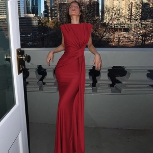 Detail of red sleeveless maxi dress featuring a twisted waist and slim silhouette