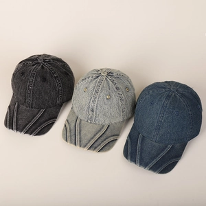 Detail of distressed washed denim baseball caps showing vintage stitching and textures