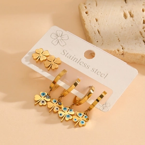 Golden stainless steel four-leaf clover earring set with blue eye details on stone base