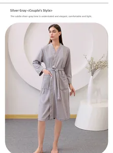 Detailed view of silver grey waffle fabric bathrobe with white piping and side pocket