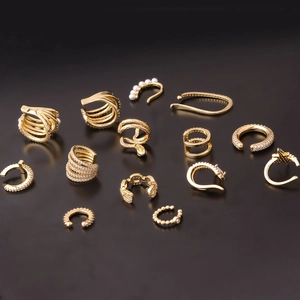 Set of 12 stylish gold ear cuffs with micro-pave zircons and faux pearls on dark background