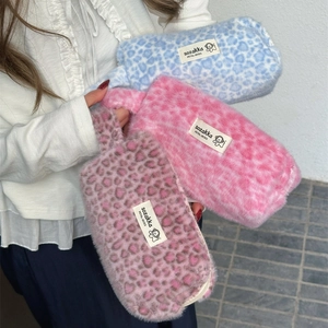 Three plush heart leopard print pencil cases held by a model in pink blue and brown