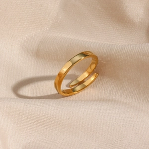 Minimalist 18k gold plated open ring with cubic zirconia on soft beige silk