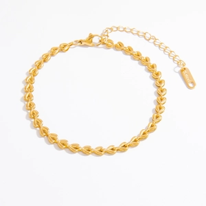 Macro shot of 18k gold plated heart chain bracelet with polished stainless steel finish