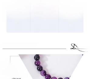Detail showing 8mm pink zebra stone beads and heart charm on handmade bracelet