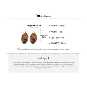 Detailed view of leaf-shaped leather earrings with vintage print and measurement scale