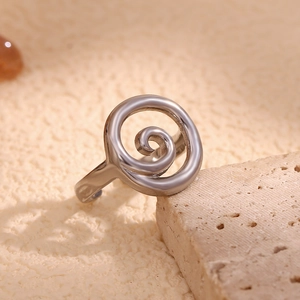 Detailed view of adjustable spiral swirl ring in polished silver finish on stone